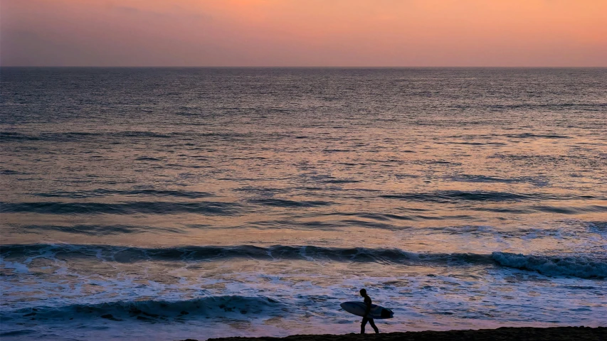 a person walking on a beach with a surfboard, by Matt Stewart, unsplash contest winner, dusk, overlooking the ocean, malika favre, lush