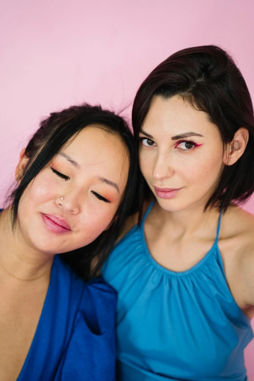 a couple of women standing next to each other, inspired by Wang Duo, reddit, synchromism, lipstick, headshot and bodyshot, blue, asian human