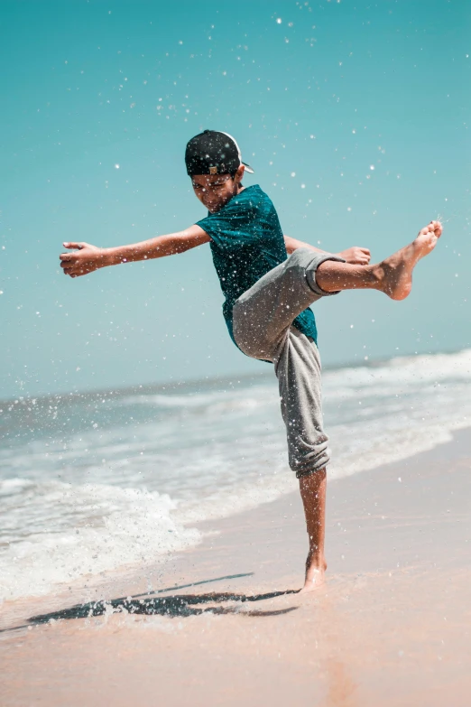 a boy kicking a frisbee on the beach, an album cover, pexels contest winner, arabesque, heroic muay thai stance pose, breakdancing, ocean spray, islamic