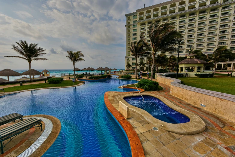 a large swimming pool next to a beach, pexels contest winner, renaissance, mexico, avatar image, wide angle shot 4 k hdr, hot tub