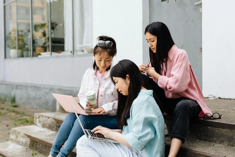 a group of women sitting on steps with laptops, trending on pexels, young asian girl, avatar image, families playing, li zixin