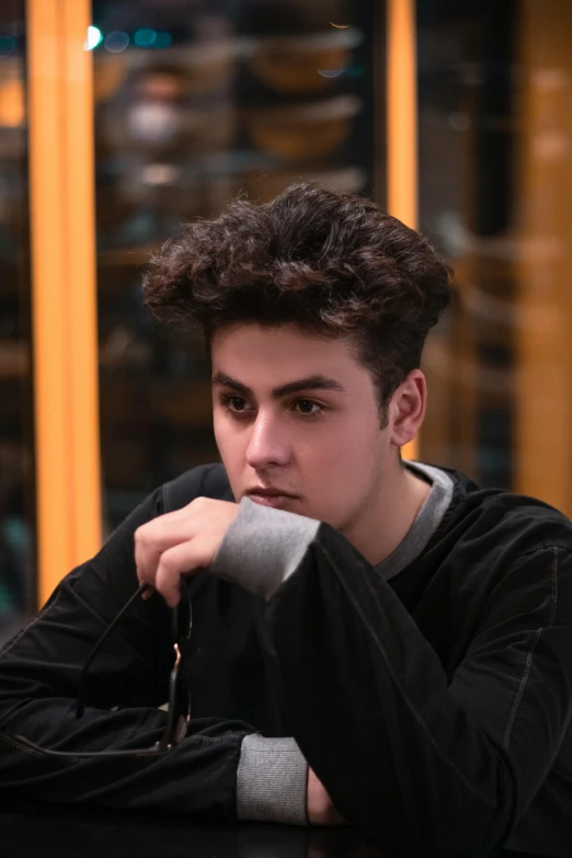 a young man sitting at a table in front of a laptop computer, an album cover, inspired by Ion Andreescu, pexels contest winner, hyperrealism, headshot profile picture, pompadour, discord profile picture, shabab alizadeh
