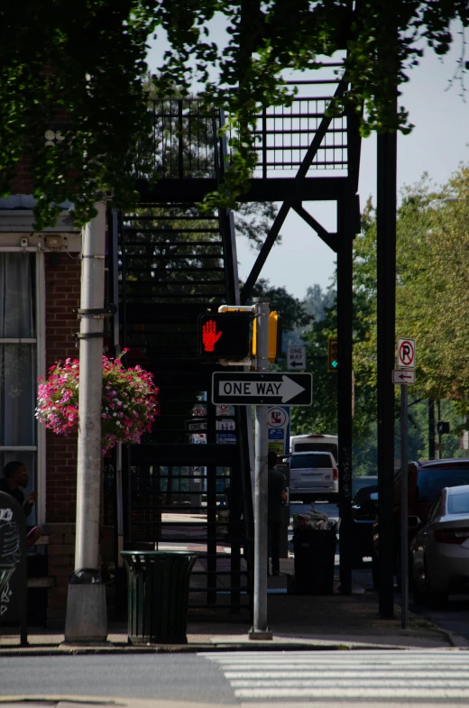 a red traffic light sitting on the side of a road, washington main street, stairway, quaint, over the shoulder