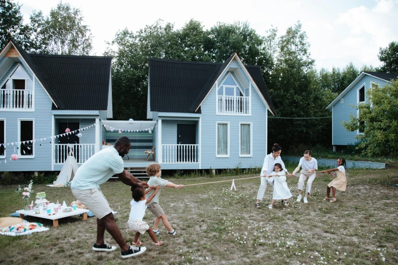 a group of people playing a game of tug rope, an album cover, by Jan Tengnagel, pexels contest winner, hurufiyya, several cottages, grey and blue theme, midsommar - t, tiny house