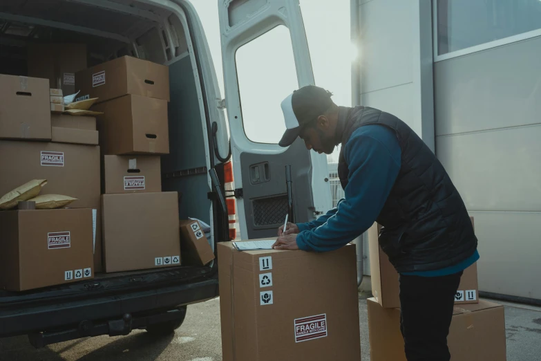a man unloading boxes into a van, pexels contest winner, ignant, avatar image, brown, high production value