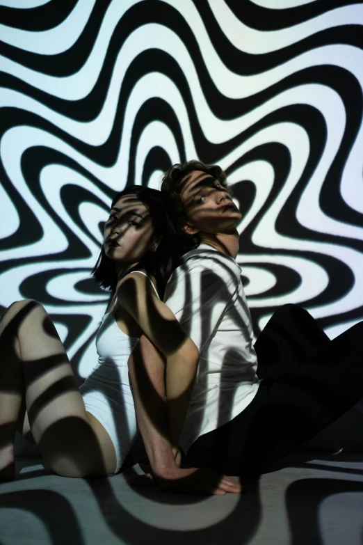 a woman that is laying down on a bed, op art, projection mapping, couple, swirling black magic, trending photo