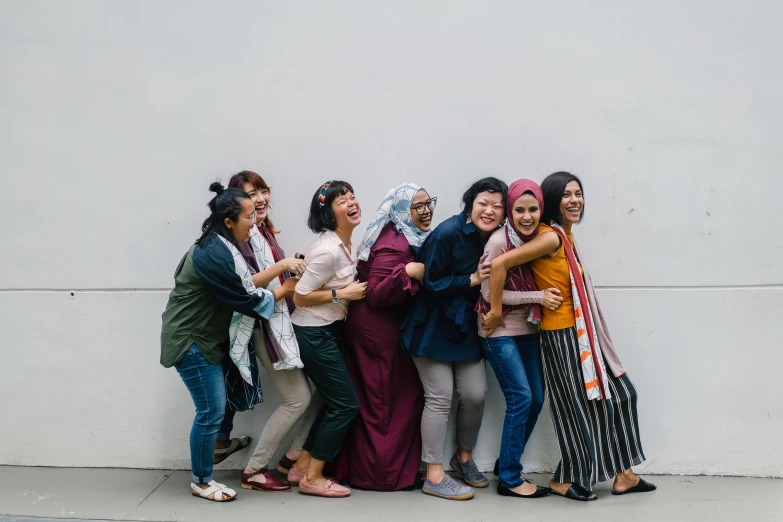 a group of women standing next to each other, a picture, pexels contest winner, all overly excited, malaysian, paisley, embraced