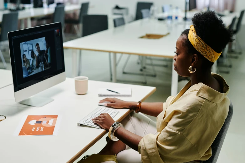 a woman sitting at a desk using a computer, a computer rendering, inspired by Afewerk Tekle, pexels contest winner, mobile learning app prototype, kodak photo, at behance, trending arstationhq