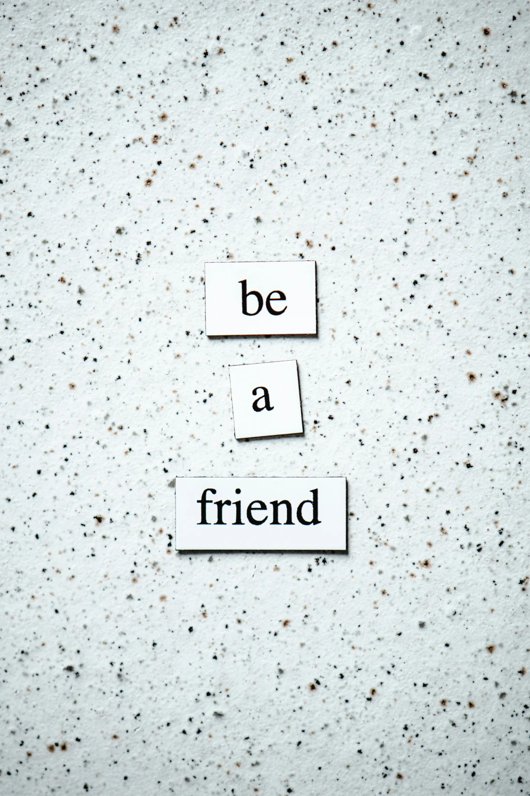 a piece of paper with the words be a friend written on it, by Emma Andijewska, unsplash, made of all white ceramic tiles, magnetic, profile picture, grey