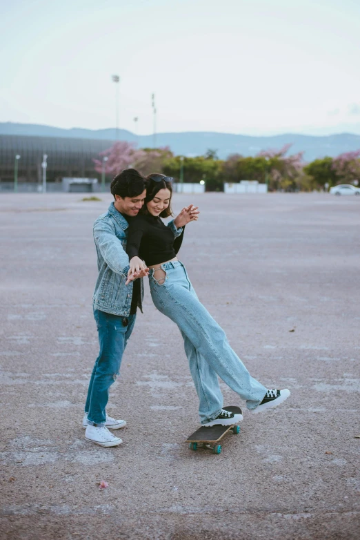 a man standing next to a woman on a skateboard, a picture, pexels contest winner, happening, dilraba dilmurat, happy couple, 🚿🗝📝