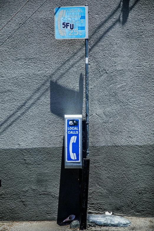 a parking meter sitting on the side of a road, an album cover, inspired by Vivian Maier, street art, flat metal antenna, blue light, telephone, los angeles 2 0 1 5