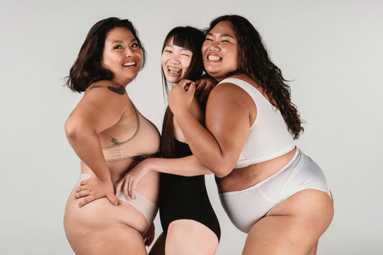 a group of three women standing next to each other, trending on pexels, big stomach, japanese collection product, ivory skin, piled around