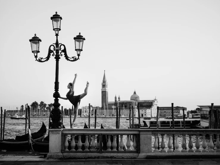 a black and white photo of a person on a bridge, arabesque, venice, high kick, fine art print, artwork