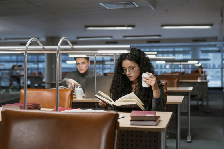 a woman reading a book in a library, pexels contest winner, people sitting at tables, avatar image, cinematic luts, fzd school of design