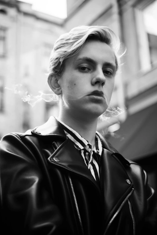 a woman in a leather jacket smoking a cigarette, a black and white photo, inspired by Oskar Lüthy, androgynous face, johan liebert, style of seb mckinnon, boy with neutral face