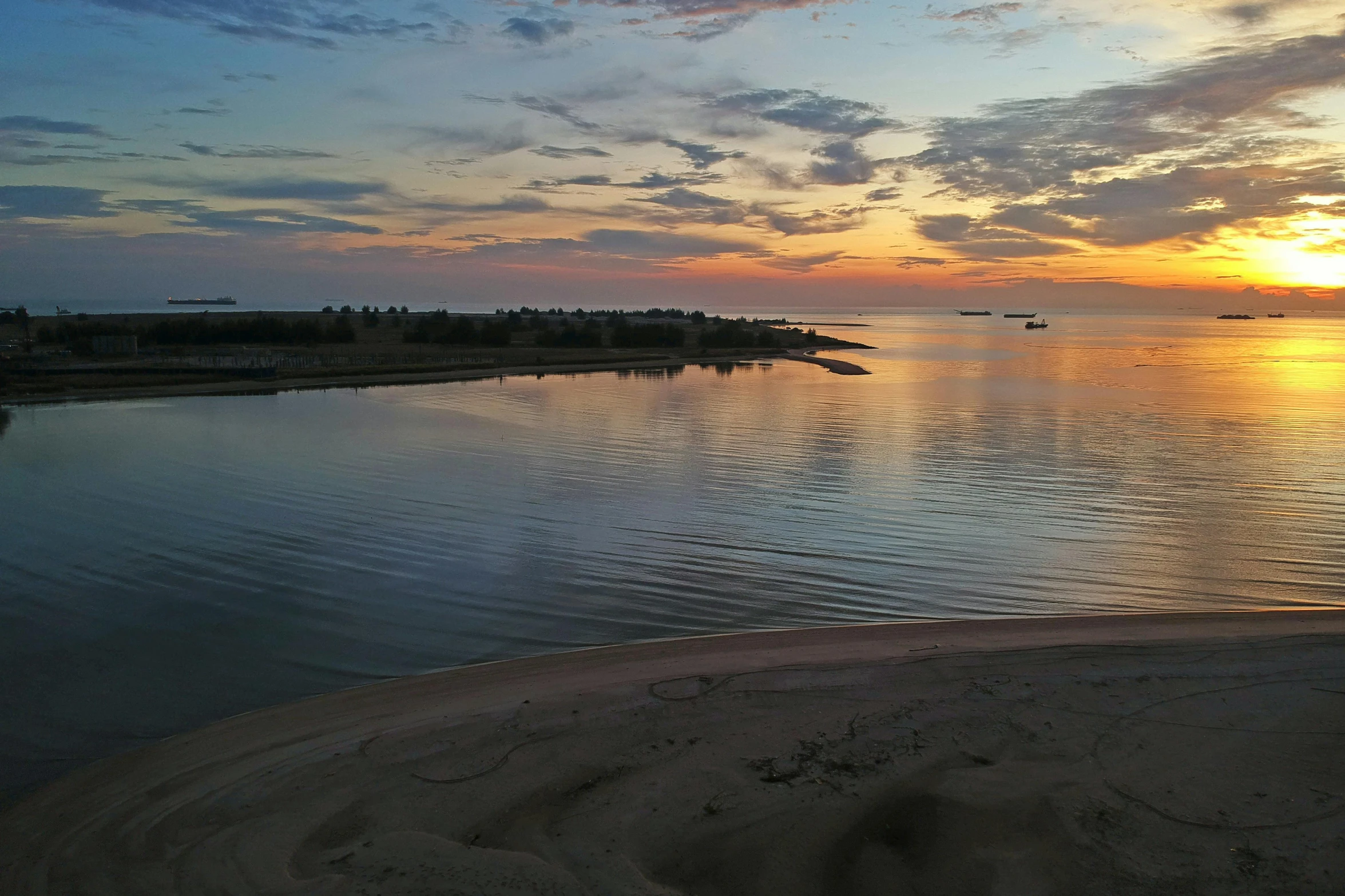 the sun is setting over a body of water, by Carey Morris, pexels contest winner, hurufiyya, sand banks, wide river and lake, photo on iphone, wide high angle view