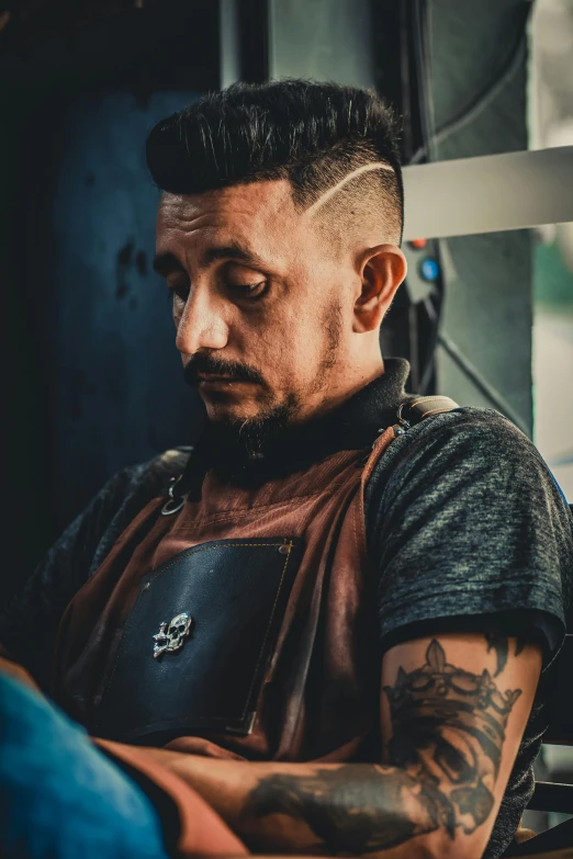 a man sitting on a bus with a tattoo on his arm, a tattoo, inspired by Eddie Mendoza, pexels contest winner, renaissance, blue mohawk hairstyle, artist wearing overalls, in a workshop, smooth symmetrical chin