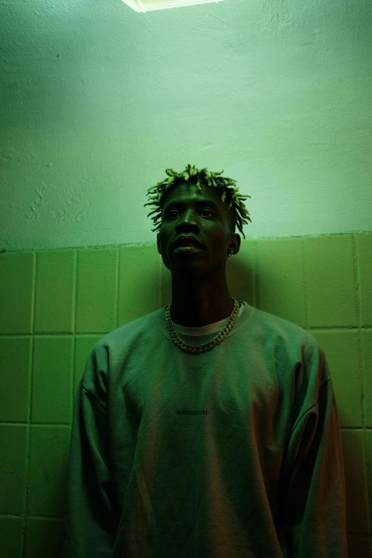 a man with dreadlocks standing in a bathroom, an album cover, trending on pexels, afrofuturism, pale green backlit glow, playboi carti portrait, greasy hair, ( ( theatrical ) )