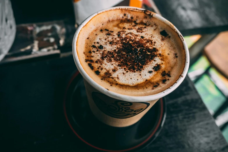 a close up of a cup of coffee on a table, trending on pexels, aussie baristas, a messy, thumbnail, 90s photo