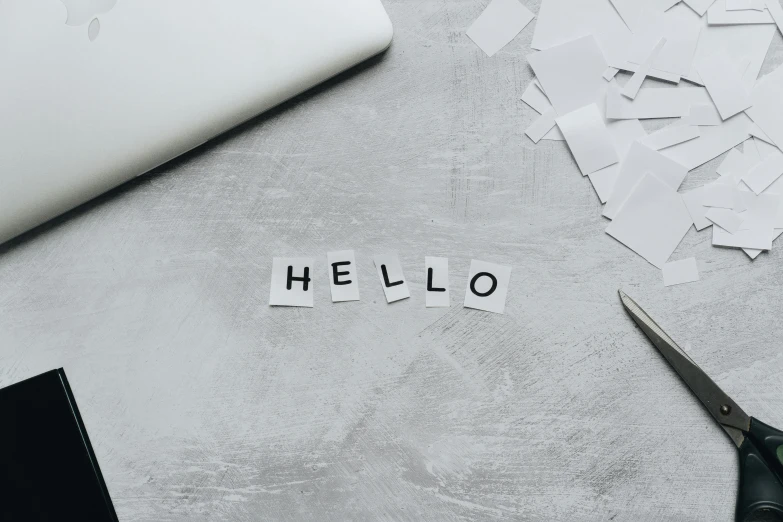 a pair of scissors sitting on top of a table, trending on pexels, new objectivity, hello world, white and grey, perfect letters, minimalist sticker