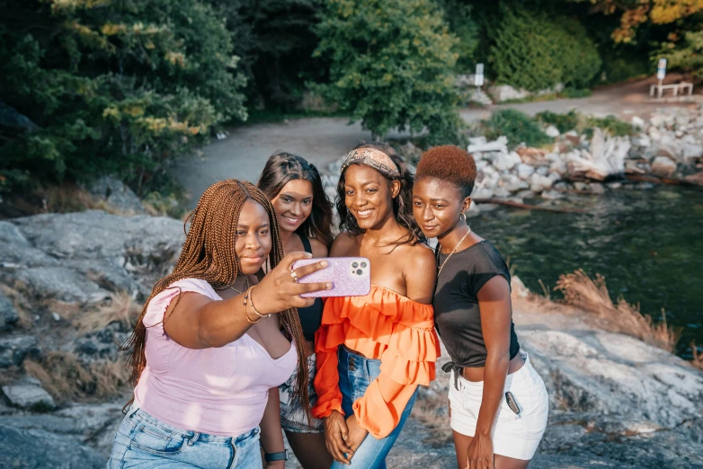 a group of women standing next to each other taking a picture, a picture, trending on pexels, happening, brown skin, photo of green river, avatar image, black teenage girl