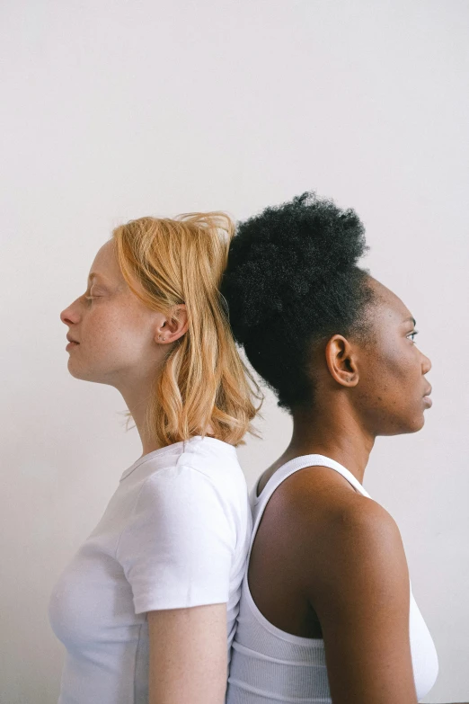 a couple of women standing next to each other, by Carey Morris, trending on unsplash, renaissance, white neck visible, short blonde afro, black on white background, woman's profile