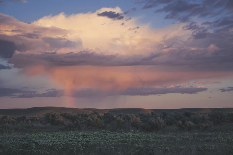 a cloudy sky with a rainbow in the distance, by Jessie Algie, unsplash contest winner, australian tonalism, prairie, mauve and cinnabar and cyan, slide show, spring evening