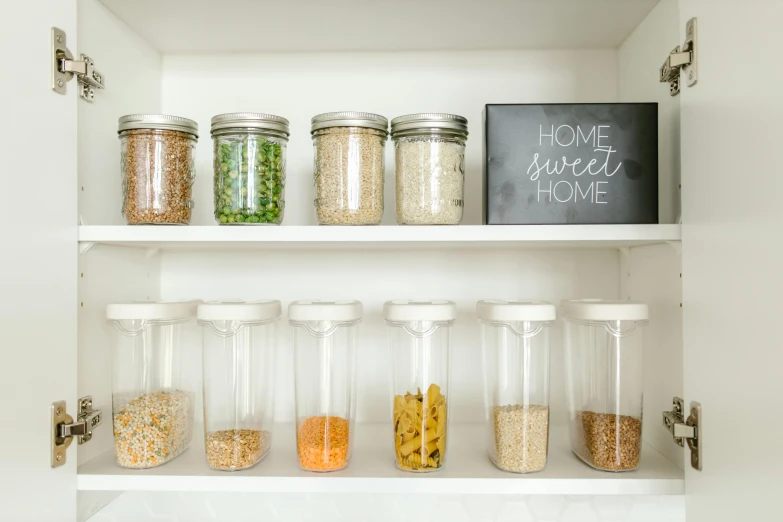 a pantry filled with lots of different types of food, by Arabella Rankin, unsplash, minimalism, flasks, fan favorite, glowing jar, dwell