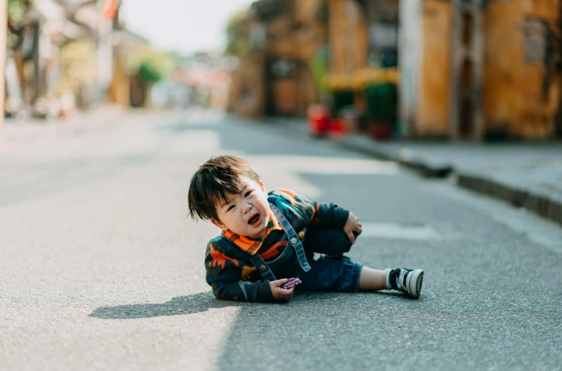 a small child sitting on the side of a road, pexels contest winner, happening, hoang lap, squinting, flattened, instagram post