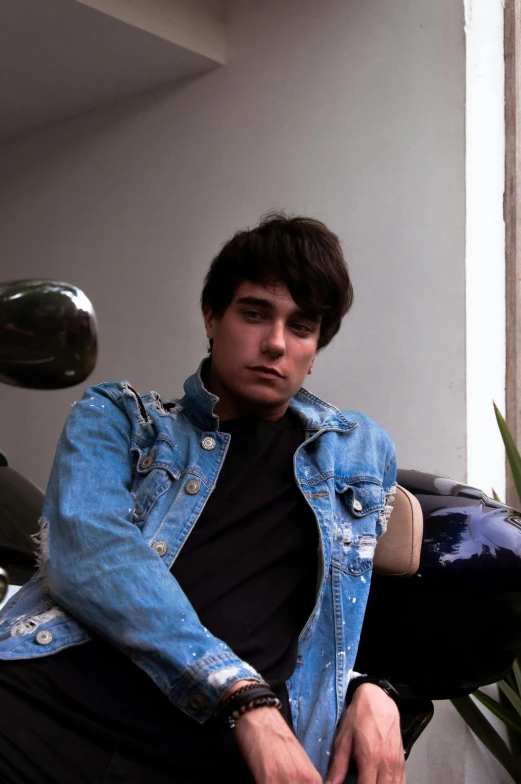 a young man sitting on top of a motorcycle, an album cover, by Cosmo Alexander, pexels contest winner, wearing a jeans jackets, non-binary, diego 5, headshot profile picture