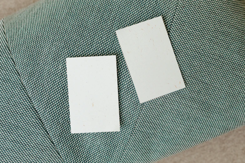 a piece of paper sitting on top of a chair, high samples, strong eggshell texture, 2 people, front and back