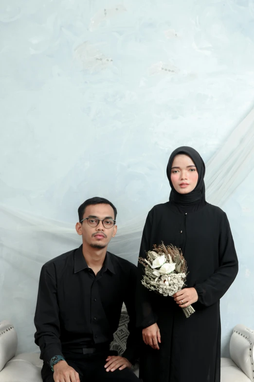 a man and a woman posing for a picture, a picture, by Basuki Abdullah, unsplash, hurufiyya, in front of white back drop, bouquet, ☁🌪🌙👩🏾, black canvas