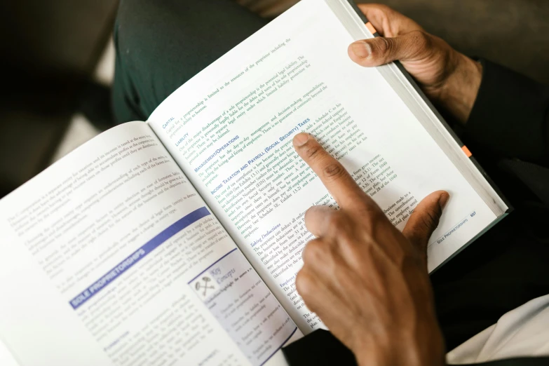 a close up of a person reading a book, instruction, detailed notes, riyahd cassiem, thumbnail