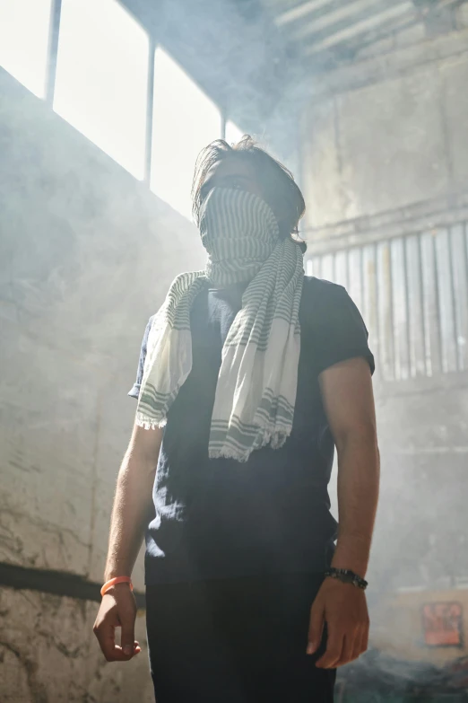 a man in a black shirt and a white scarf, unsplash, inside a gang hideout, face obscured, in a warehouse, india