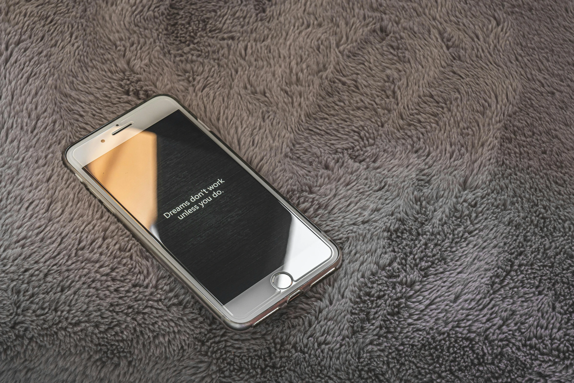 a close up of a cell phone on a blanket, by Robbie Trevino, pexels, realism, gradient brown to silver, dark grey carpet, realistic 3d model, hidden message