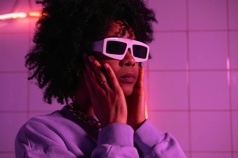a woman with a pair of glasses on her face, an album cover, trending on pexels, afrofuturism, brightly lit purple room, gamer aesthetic, white neon, cinematic outfit photo