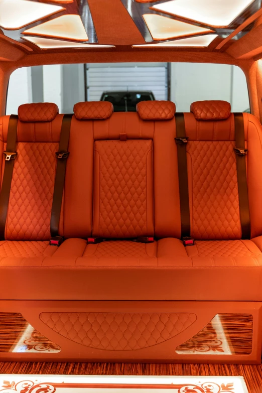 the interior of a car with orange leather seats, by derek zabrocki, baroque, rear lighting, 256x256, bench, ready - made