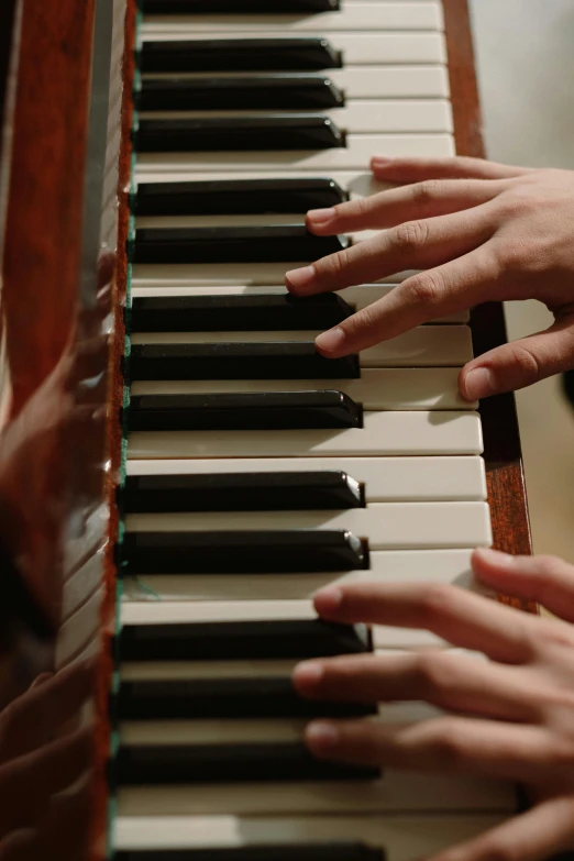 a close up of a person playing a piano, four hands, cinematic shot ar 9:16 -n 6 -g, traditional medium, brown