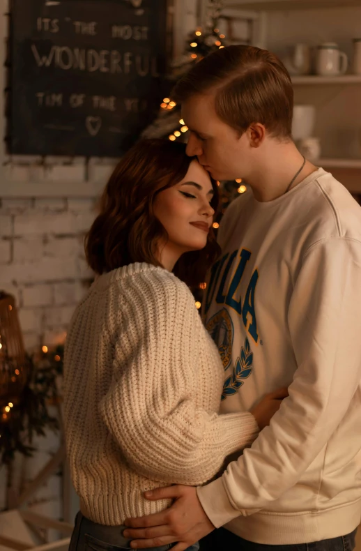 a man and a woman standing next to each other, pexels, romanticism, cozy lights, wearing sweater, ad image, brunette