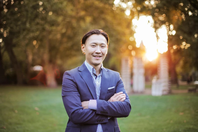 a man in a suit and tie standing in a park, jen yoon, warmly lit, portrait image, feng zhu |