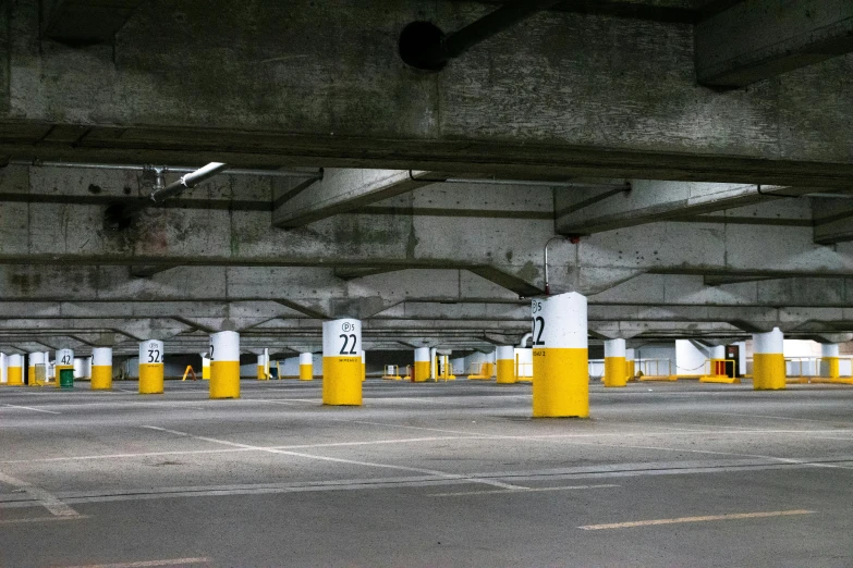 a parking garage filled with lots of parking spaces, a photo, unsplash, postminimalism, white and yellow scheme, concrete pillars, promo image, square