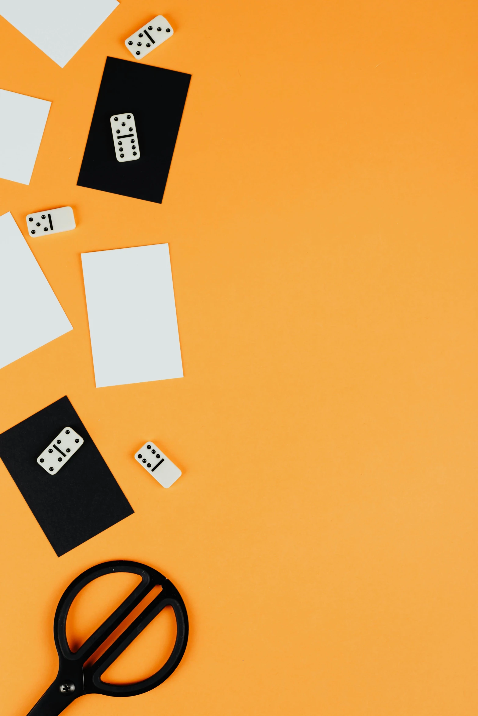 a pair of scissors sitting on top of a piece of paper, an album cover, trending on unsplash, hypermodernism, playing cards, orange and black, cubes on table, thumbnail