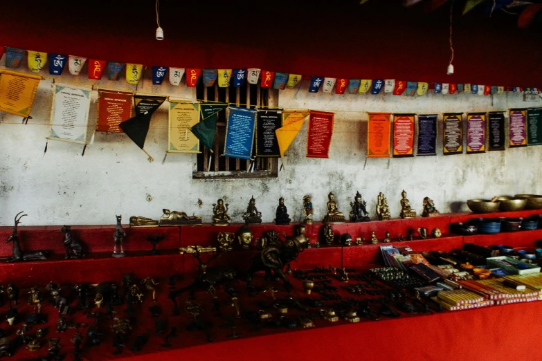 a room filled with lots of different items, unsplash, cloisonnism, red banners, nepal, weapon shop interior, thumbnail