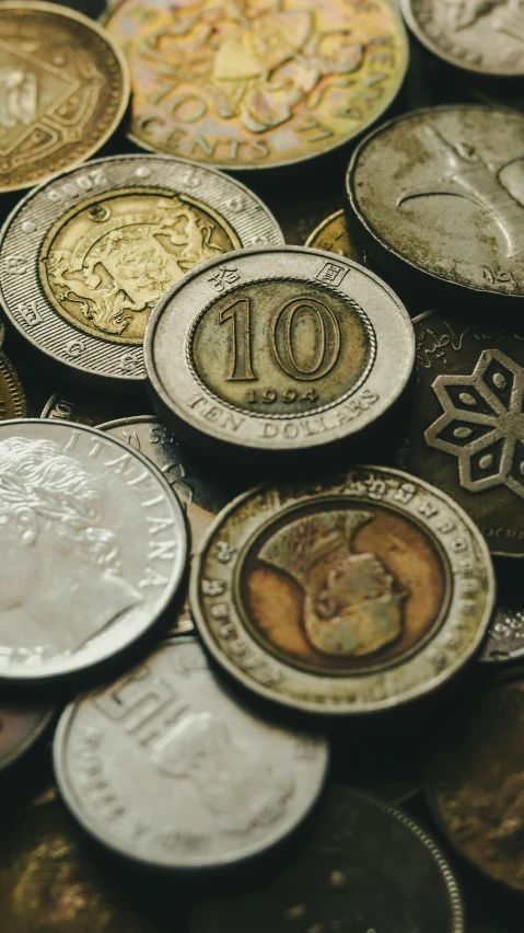 a pile of coins sitting on top of each other, pexels, mingei, zoomed view of a banknote, silver dechroic details, hi-res, uk