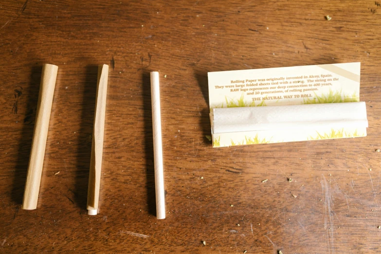 a couple of chopsticks sitting on top of a wooden table, instructions, smoking a joint, packaging, thumbnail