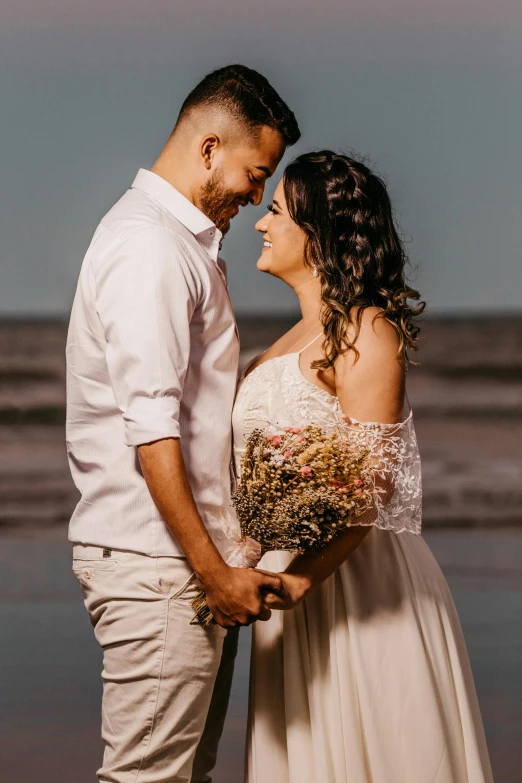 a man and woman standing next to each other on a beach, pexels contest winner, renaissance, bouquet, hispanic, rustic, looking her shoulder