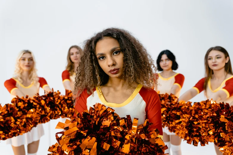a group of cheerleaders holding pom poms, pexels contest winner, antipodeans, white and orange breastplate, looking serious, ashteroth, publicity cosplay