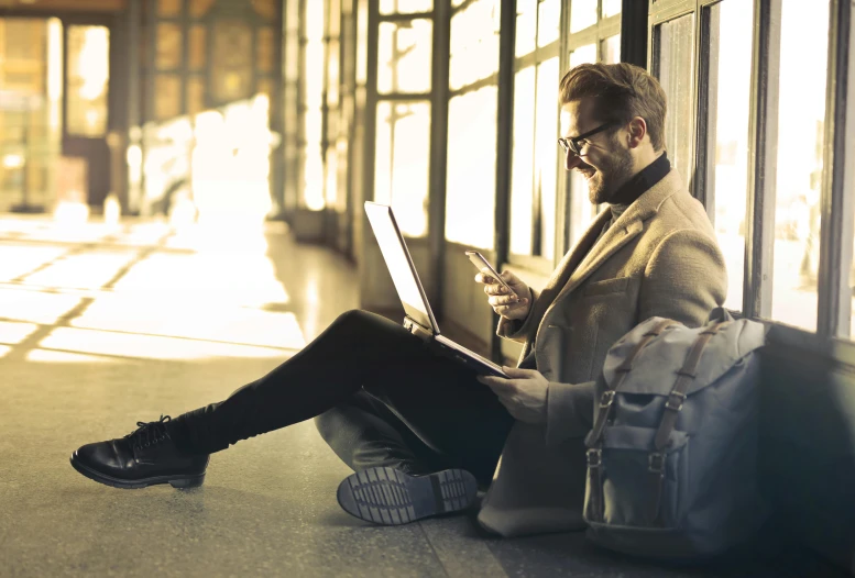 a man sitting on the ground using a laptop, pexels contest winner, supersonic trains and passengers, australian, avatar image, profile picture