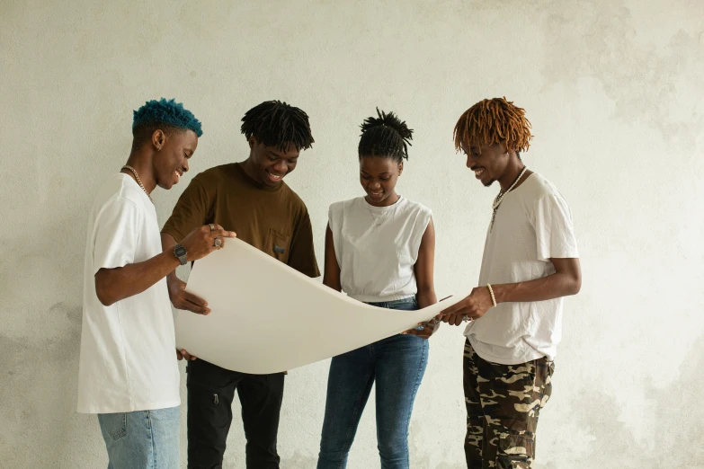a group of people looking at a piece of paper, pexels contest winner, black arts movement, white shirt and blue jeans, building plans, squad, black teenage boy