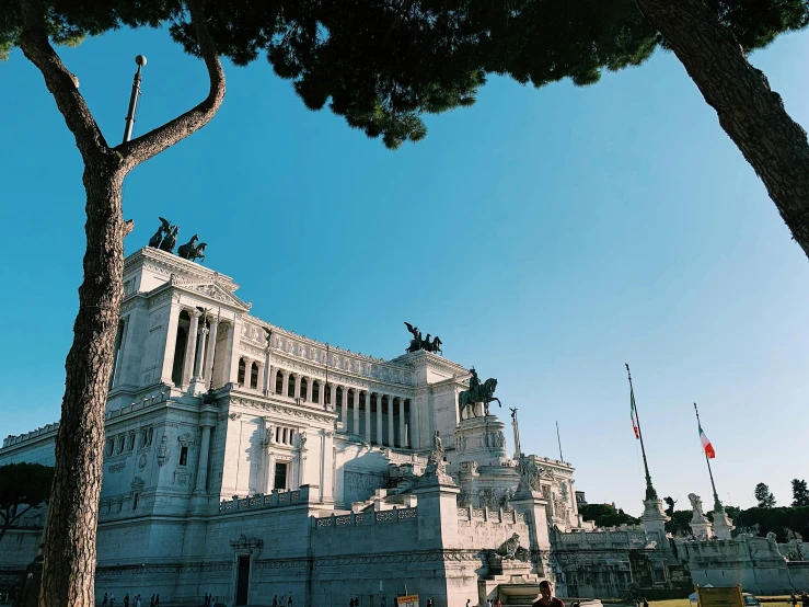 a large white building with a tree in front of it, a marble sculpture, inspired by Mirabello Cavalori, pexels contest winner, alma tadema, military buildings, square, parce sepulto